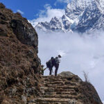 Men walk on a deserted mountain path during a government-imposed nationwide lockdown as a preventive measure against the COVID-19 coronavirus, in Namche Bazar in the Everest region, some 140 Kms northeast of Kathmandu on March 25, 2020. (Photo by PRAKASH MATHEMA / AFP) (Photo by PRAKASH MATHEMA/AFP via Getty Images)